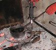 Dipping iron in molten lead, before it is set into stone at the Château de St-Ferriol