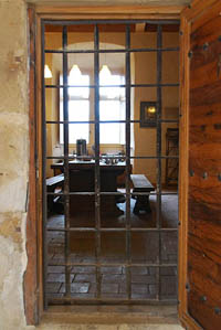 The kitchen door has a yett - a metal gate, similar in principle to a portcullis, except that it opens like a door. Here the yett is closed but the door is open. Defensive features like this are also common in Scotland